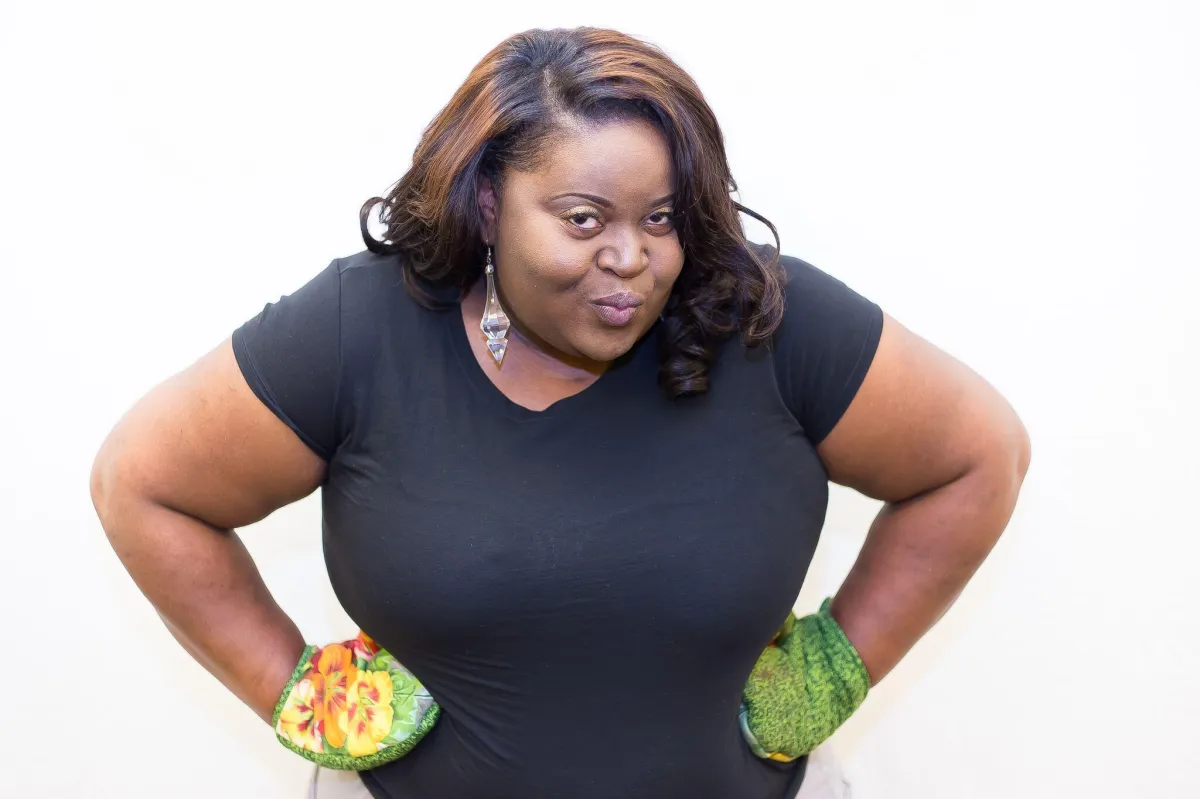 Teacher wearing oven mitts demonstrating a fun and interactive family cooking class