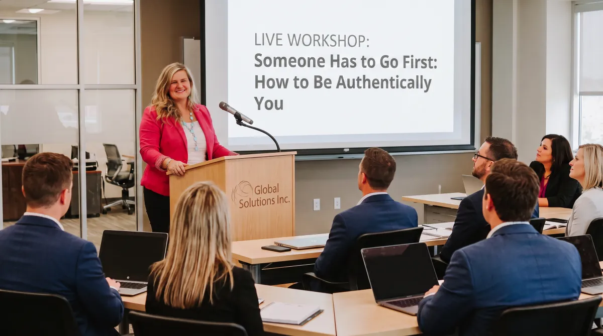 Susie standing at podium at a workshop