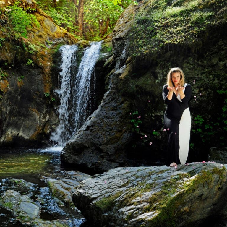 woman in black shirt and black pants sitting on bed