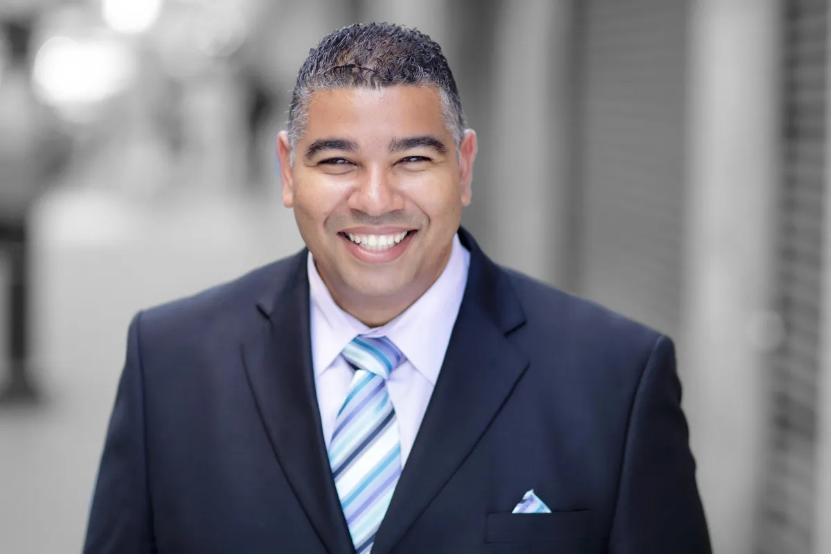 A graphic showing a young woman with VR glasses navigating the follow up beast system 'Home Page' amidst a backdrop of soft-toned watercolor digital icons and elements.