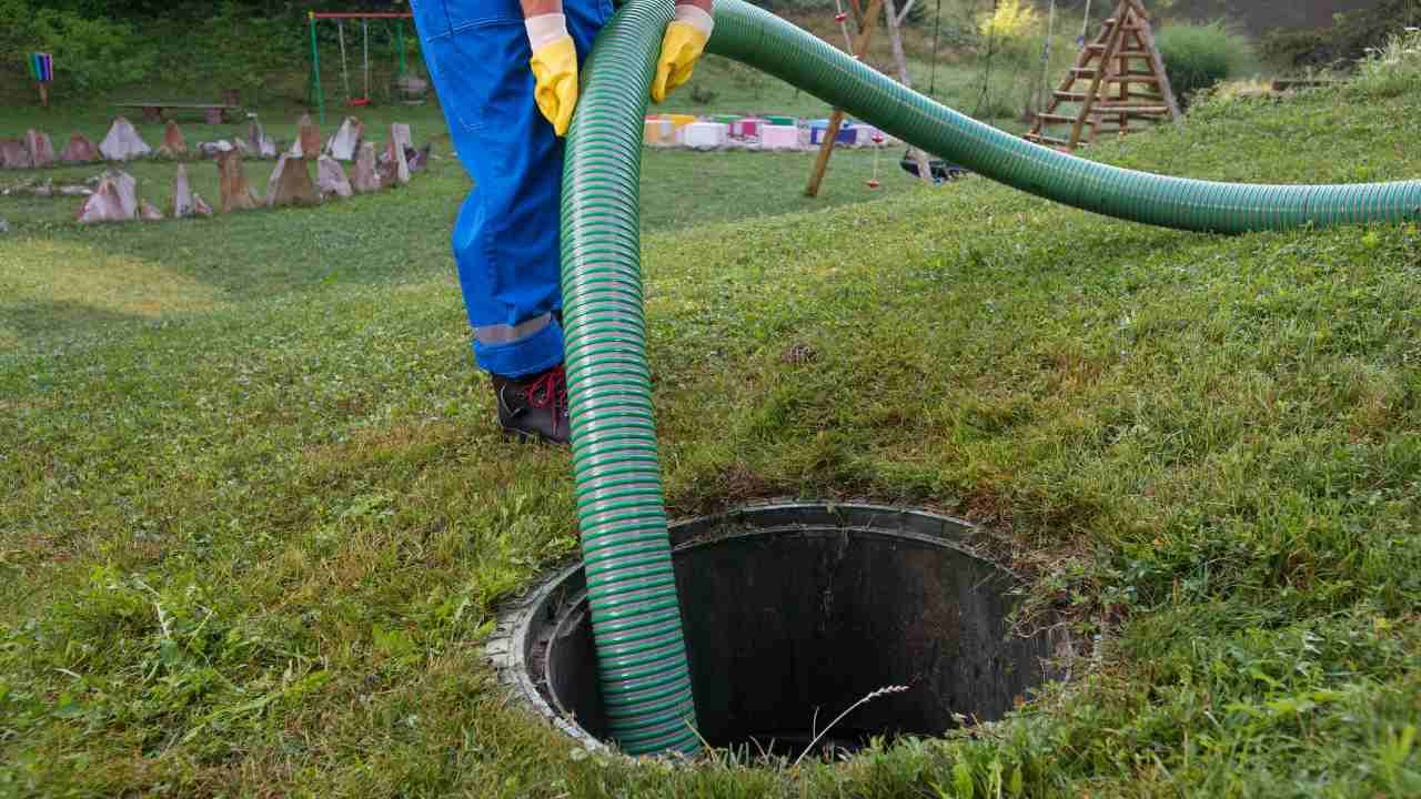 Man pumping sewage into the septic tank
