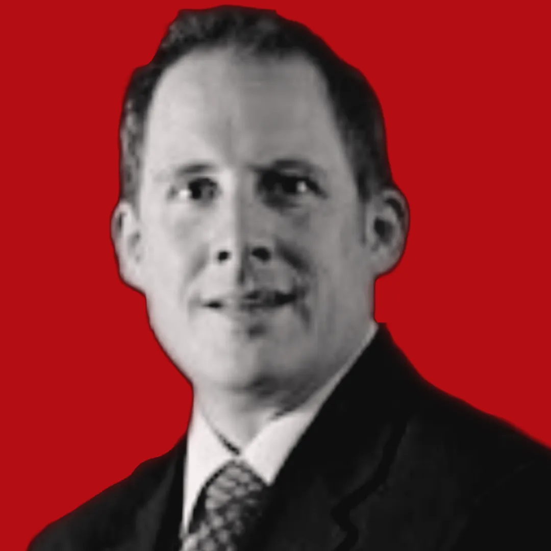 A black and white headshot of Phil Boggess, an E on a Red Background, an estate planning lawyer,
