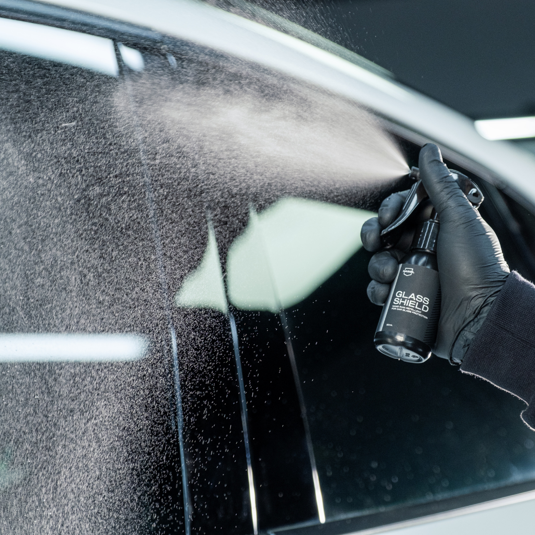 person in white robe holding black and yellow umbrella