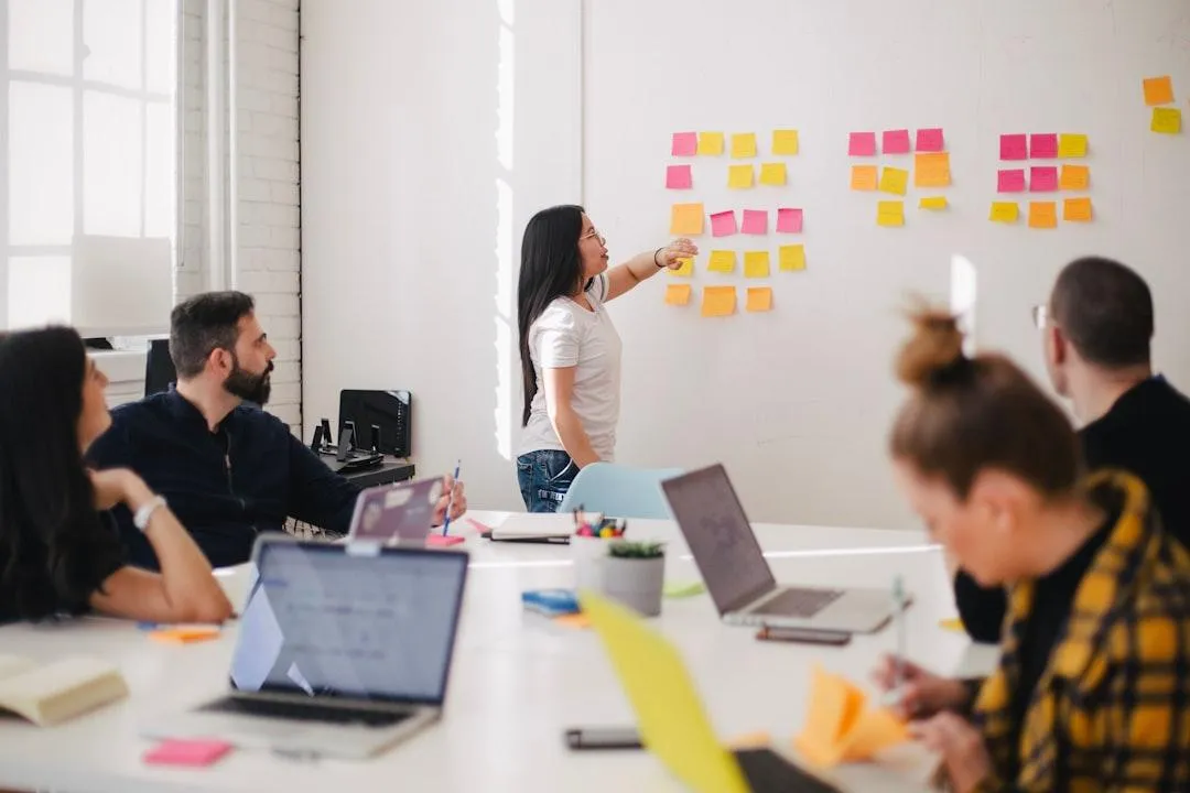 meeting with sticky notes on a whiteboard