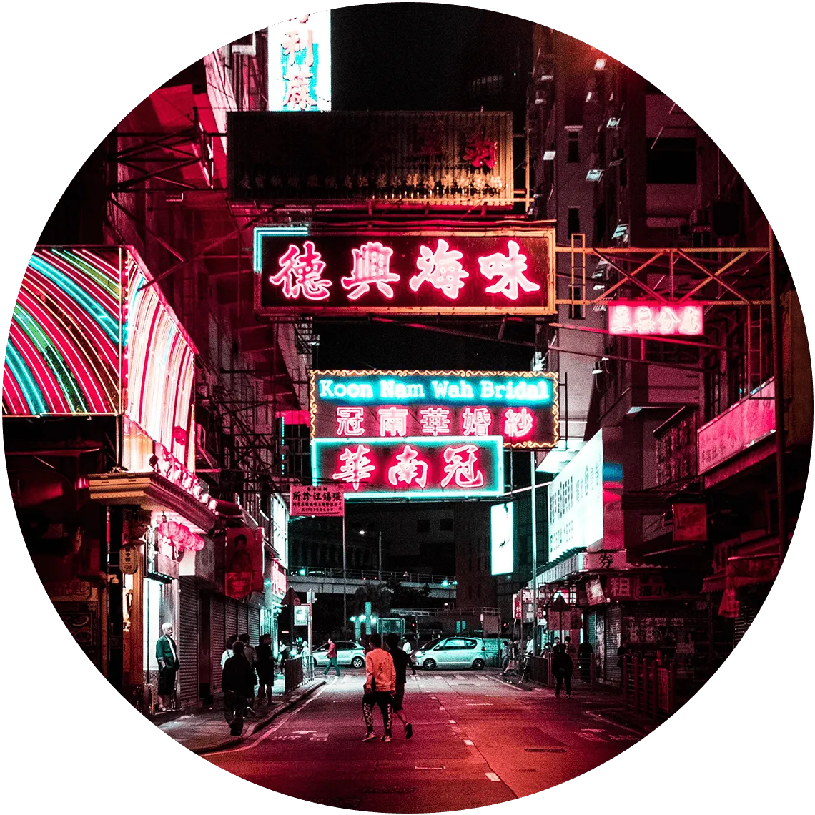 Iconic neon signs illuminating a bustling street in Hong Kong, highlighting the city’s vibrant nightlife.