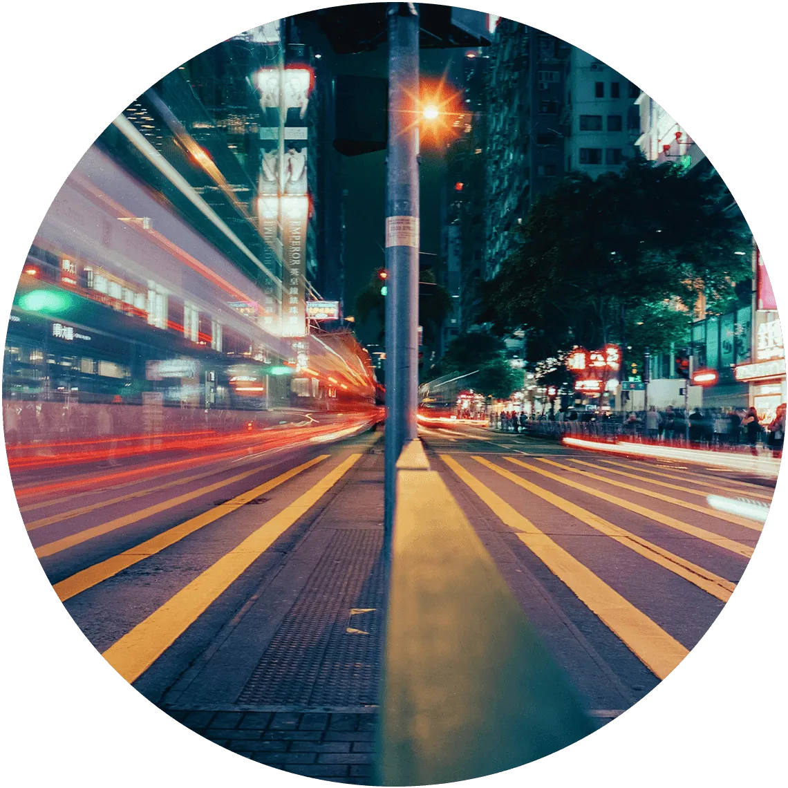 Vibrant night scene of a busy urban street in Hong Kong with blurred lights and dynamic motion.