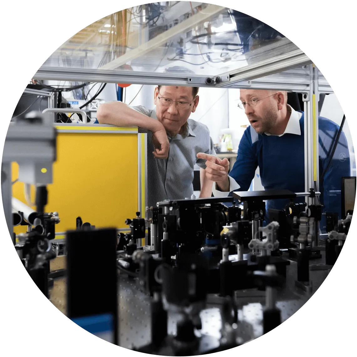 Engineers collaborating in a high-tech laboratory, focusing on precision manufacturing solutions