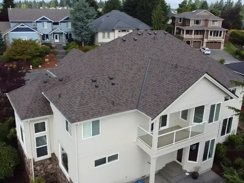 New asphalt shingle roof with ridge box vents installed on a two-story home in Pierce County, WA