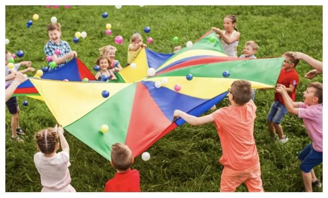 Kids moving with the teacher on a large screen TV