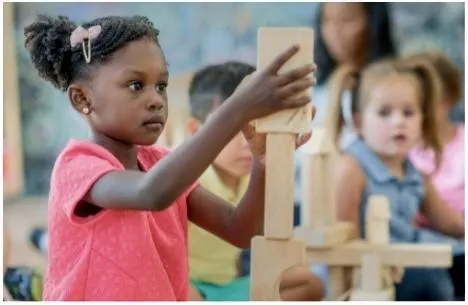 Girl follows directions during arts and crafts time.
