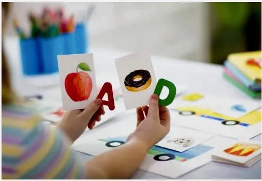 Girl watches a lesson about the alphabet on a laptop