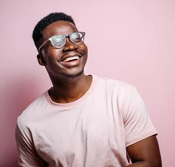 A smiling man in glasses looking up, indicating positive payout reviews for fullpayout.