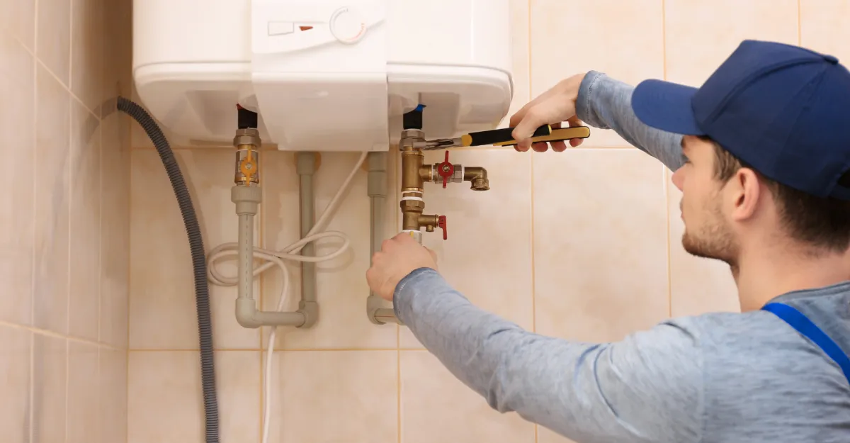 A red tiled bathroom with a chrome faucet