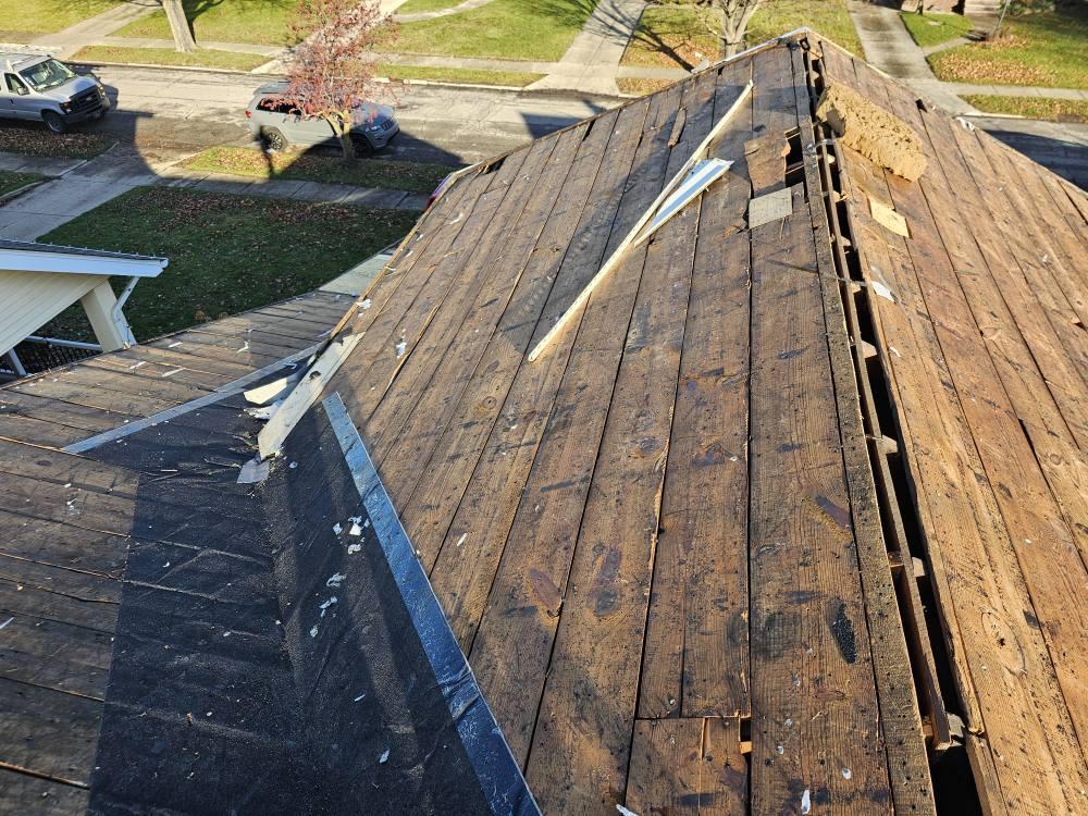 Old roof decking with ridge gap and loose boards during full roof tear-off in Northeast Ohio by Rockstar Roofing