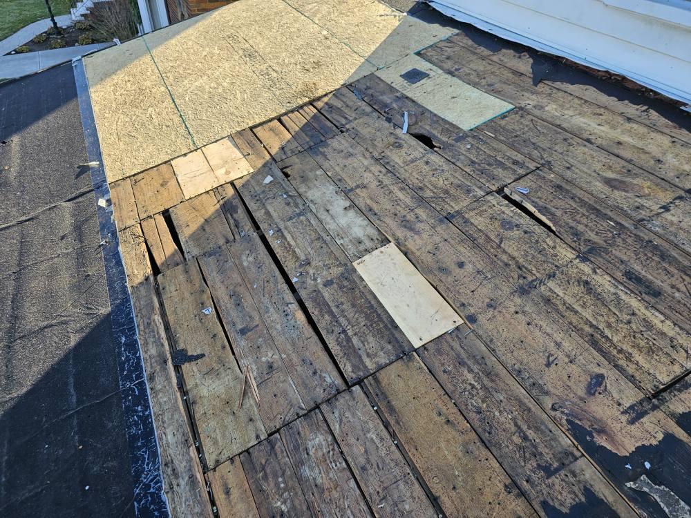 Owens Corning Duration shingles being installed during full roof replacement in snowy Ohio neighborhood
