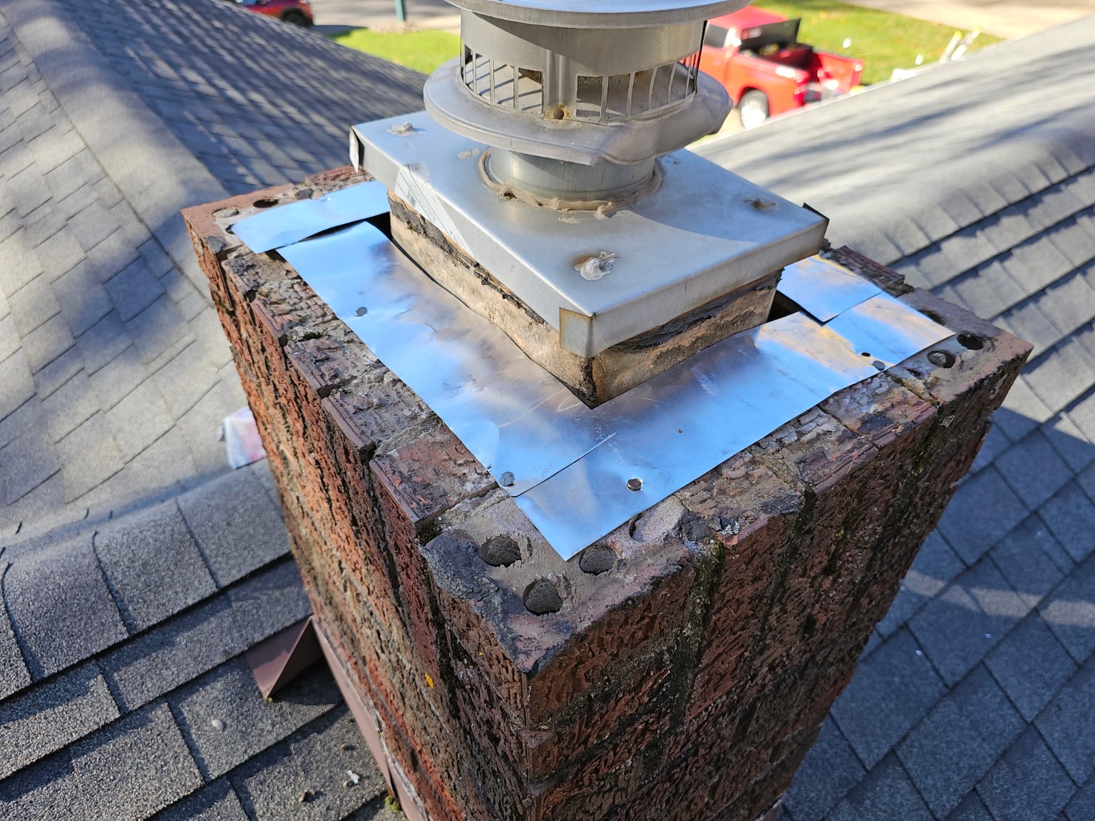 Custom metal chimney flashing installation by Rockstar Roofing in Ashtabula, Ohio providing long-term leak protection.