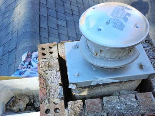 Severely damaged chimney crown and deteriorating mortar joints during roof inspection in Ashtabula, OH — pre-repair photo by Rockstar Roofing.