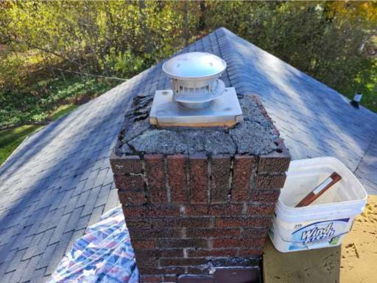 Old brick chimney in Ashtabula, Ohio showing cracked crown and water damage before chimney repair by Rockstar Roofing