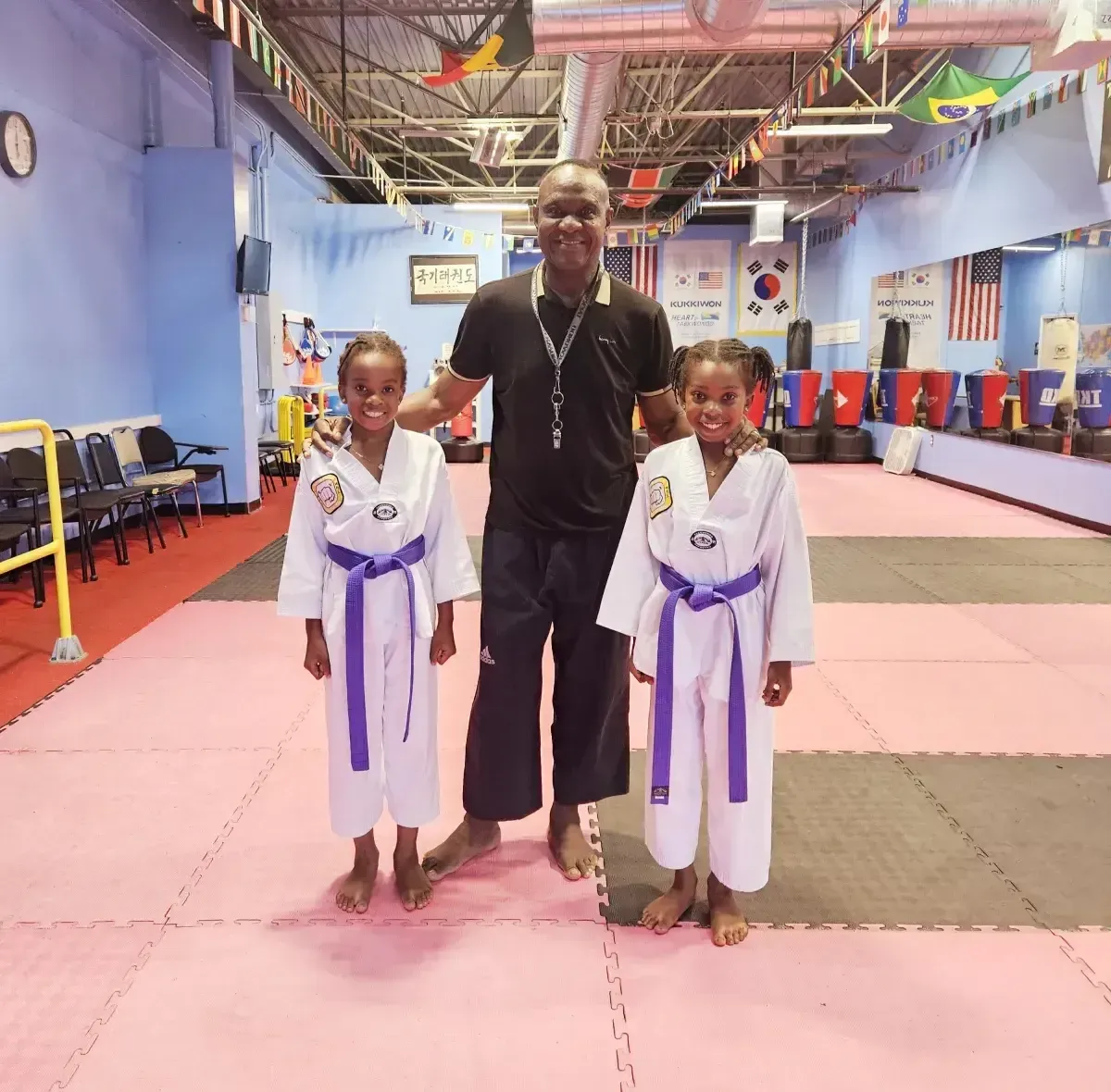 Picture of one of the instructors of the school teaching a young girl