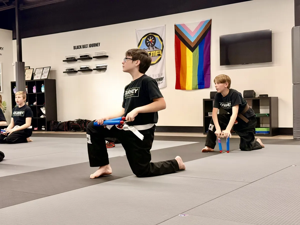Preschool child having fun hitting training bag