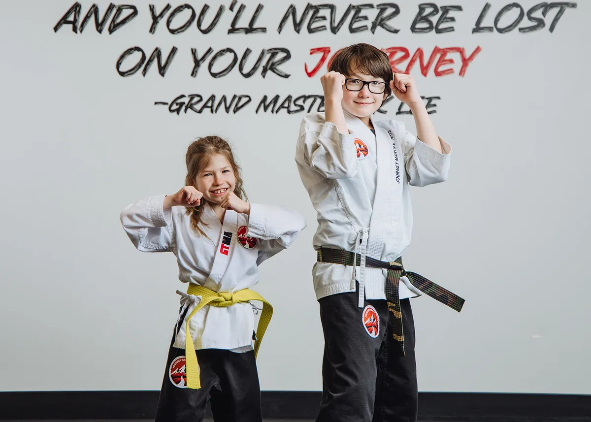 Martial arts instructor guiding young students