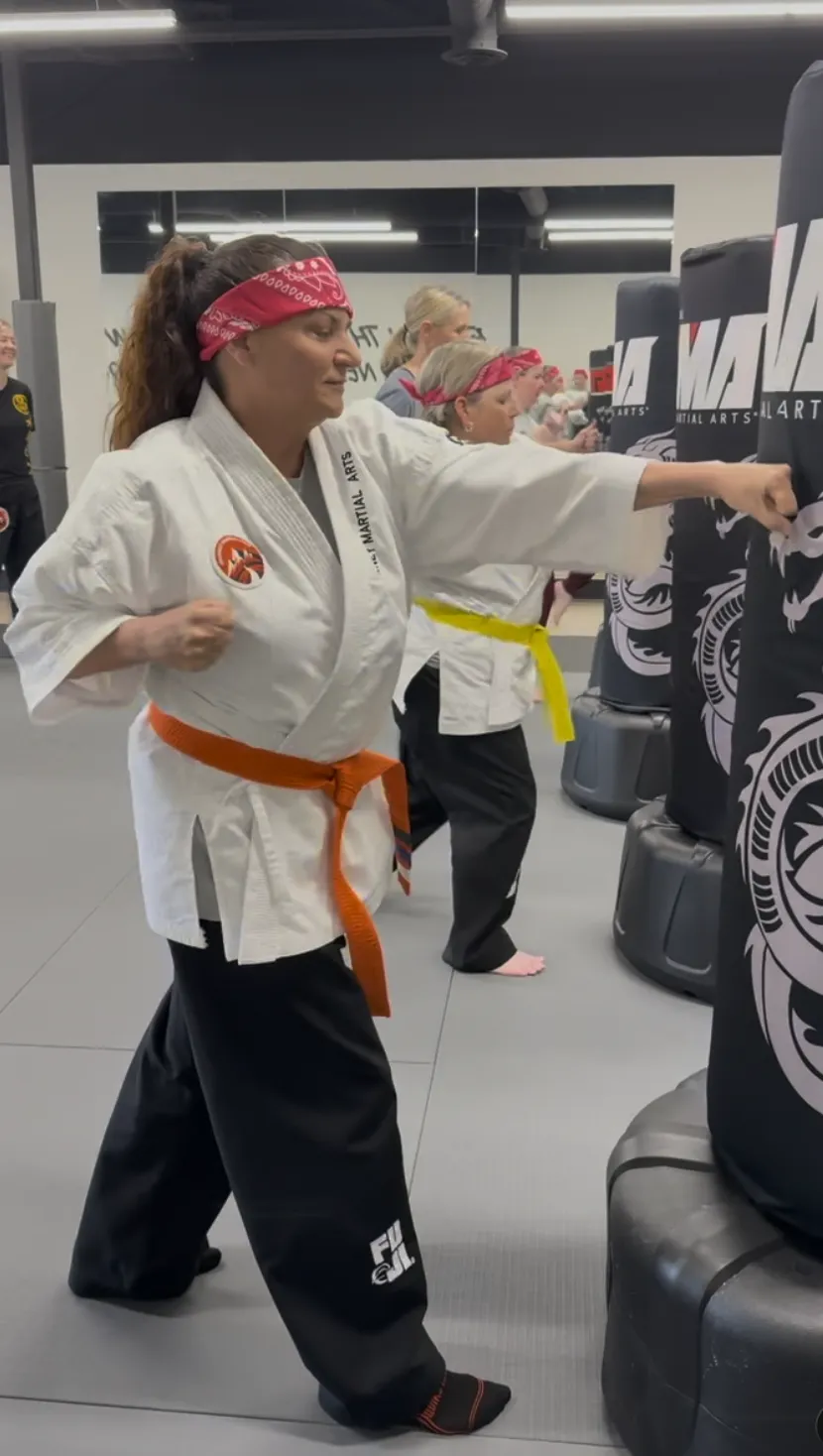 Preschool martial arts student practicing kick
