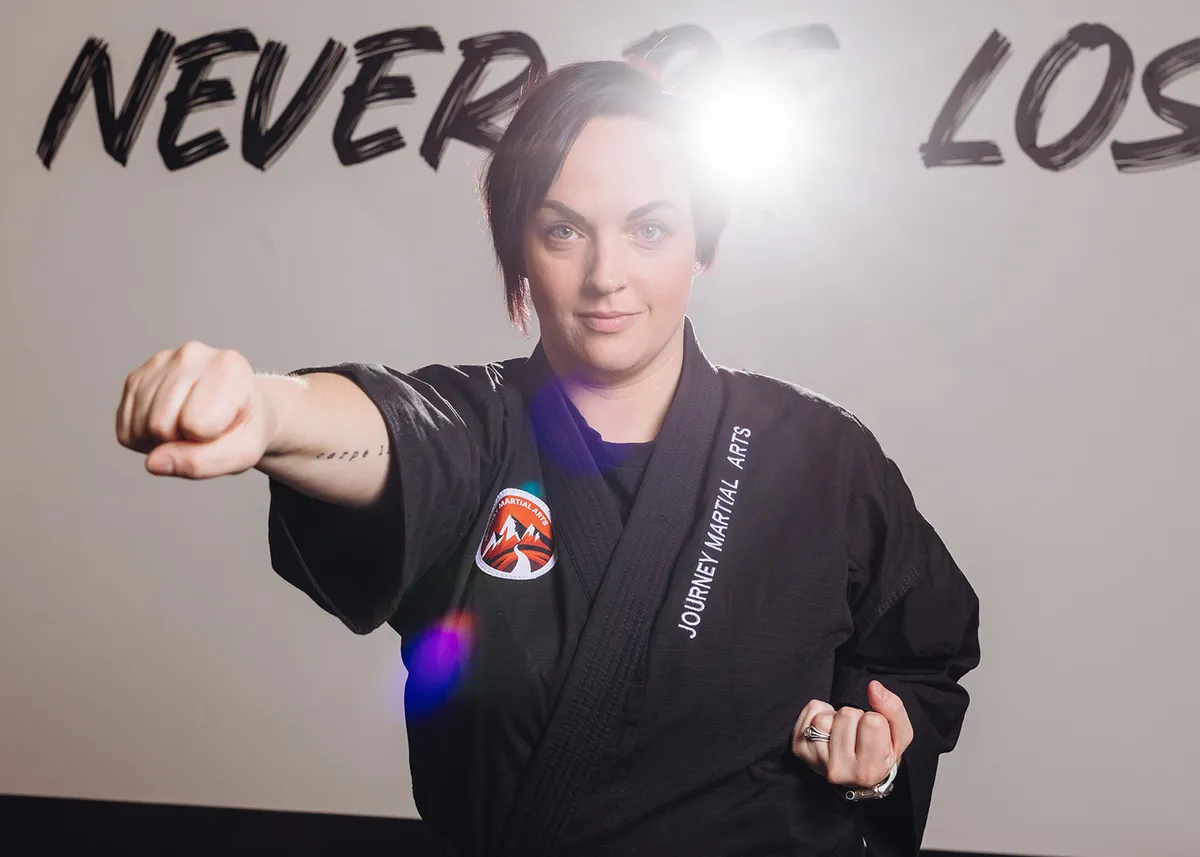 Martial arts instructor guiding young students