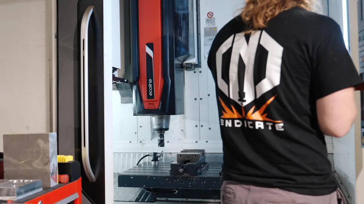 Shop owner Max working on a CNC machine at CNC Syndicate in Ravenswood WV, highlighting custom CNC machining and high-tolerance part production