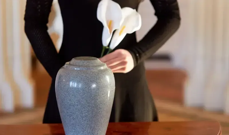 Funeral director reviewing paperwork with client — Crematie