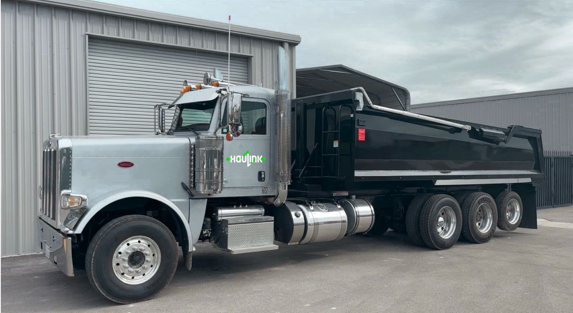 Modern logistics operations center with fleet monitoring screens and dispatch management team