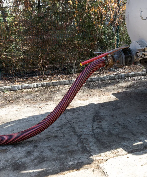 Close-up of worker connecting vacuum hose for septic pumping service
