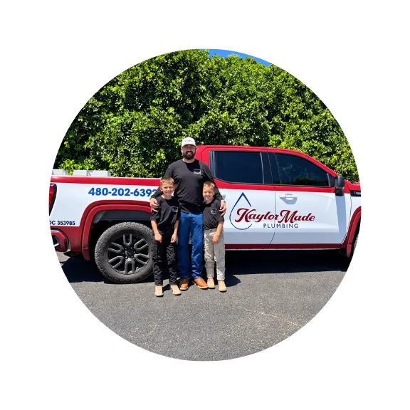 KaylorMade Plumbing owner with family in front of branded plumbing service truck