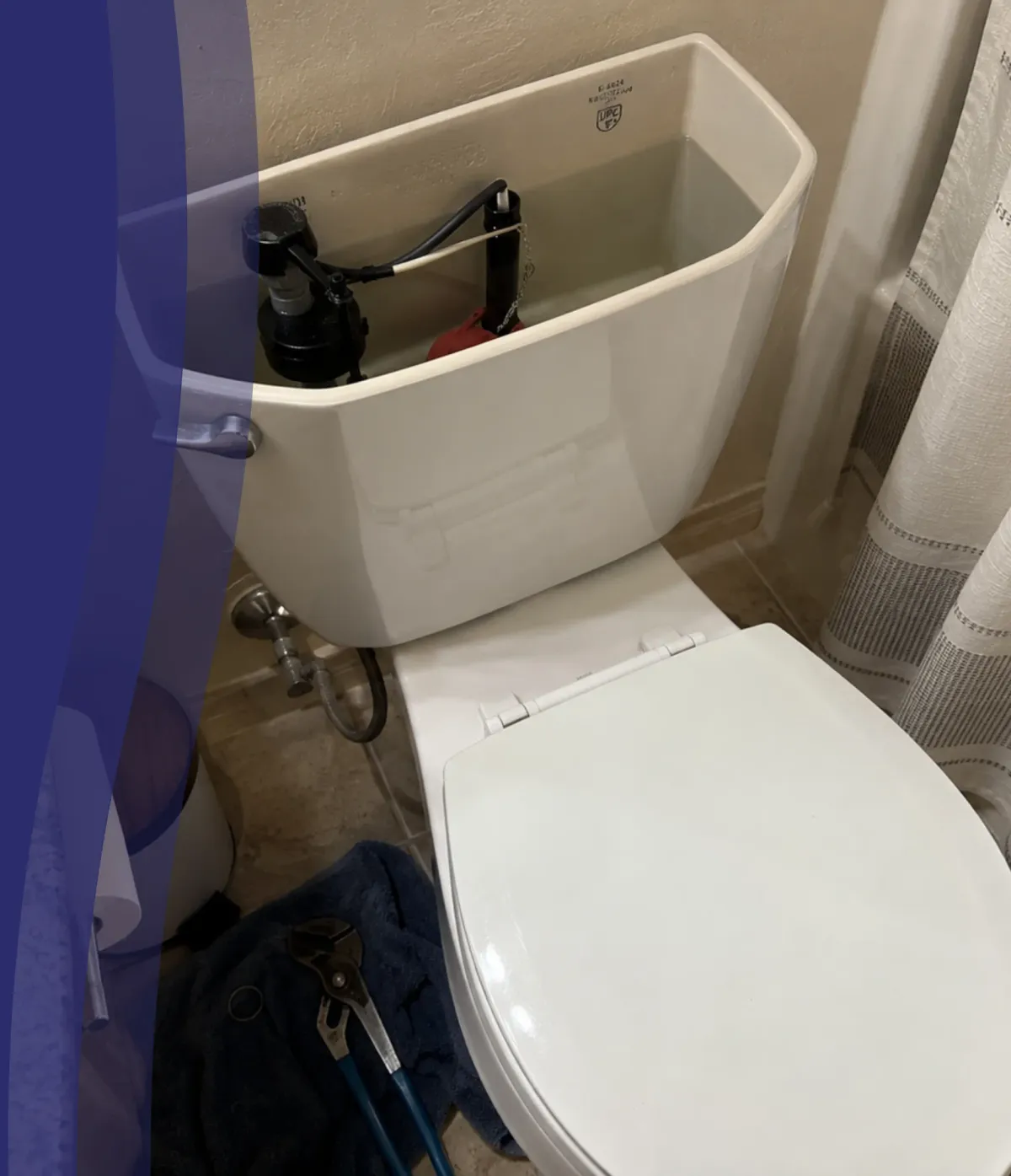 An open toilet tank showing the fill valve and water, with pliers on a blue towel on the floor below.