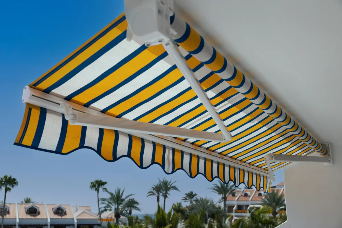 Custom retractable awning installed on a condo deck in Sarasota, Florida, providing shade and comfort for outdoor living in a multi-story building