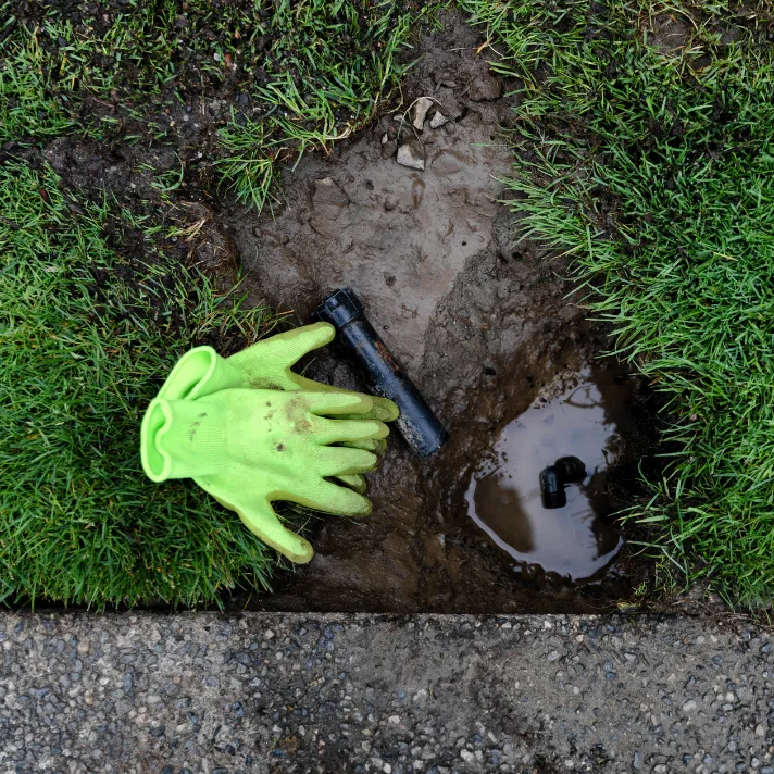 A technician performing routine maintenance on a sprinkler system in Austin, ensuring optimal performance and longevity.