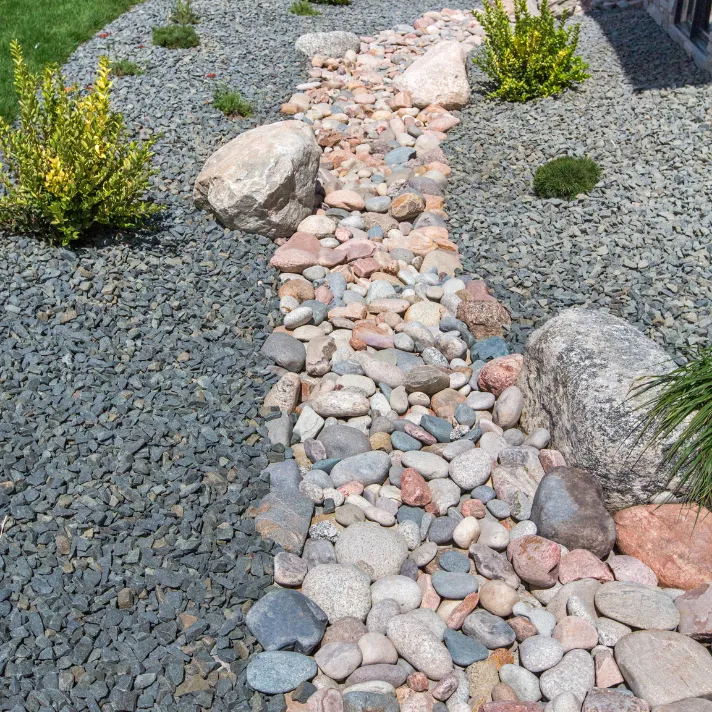 A stunning stone pathway winding through a landscaped garden in Austin, adding visual interest and functionality.