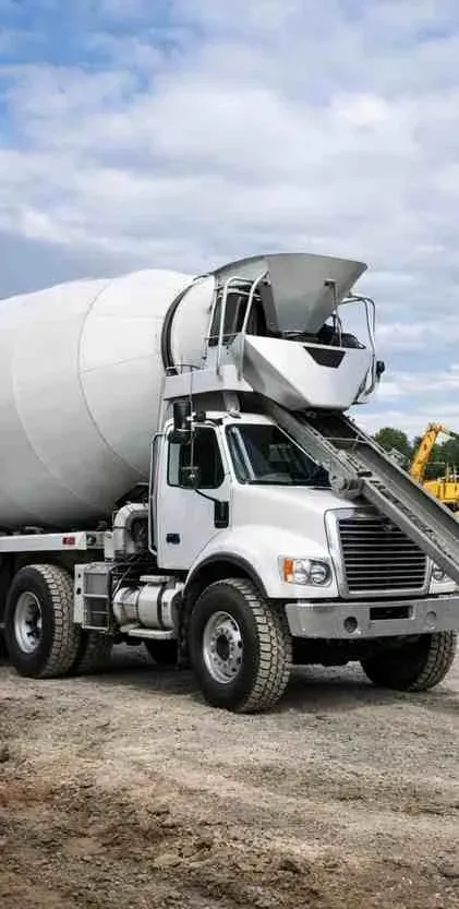 Freshly replaced smooth concrete driveway with beveled edges in Arlington TX, featuring lush landscaping and modern home.