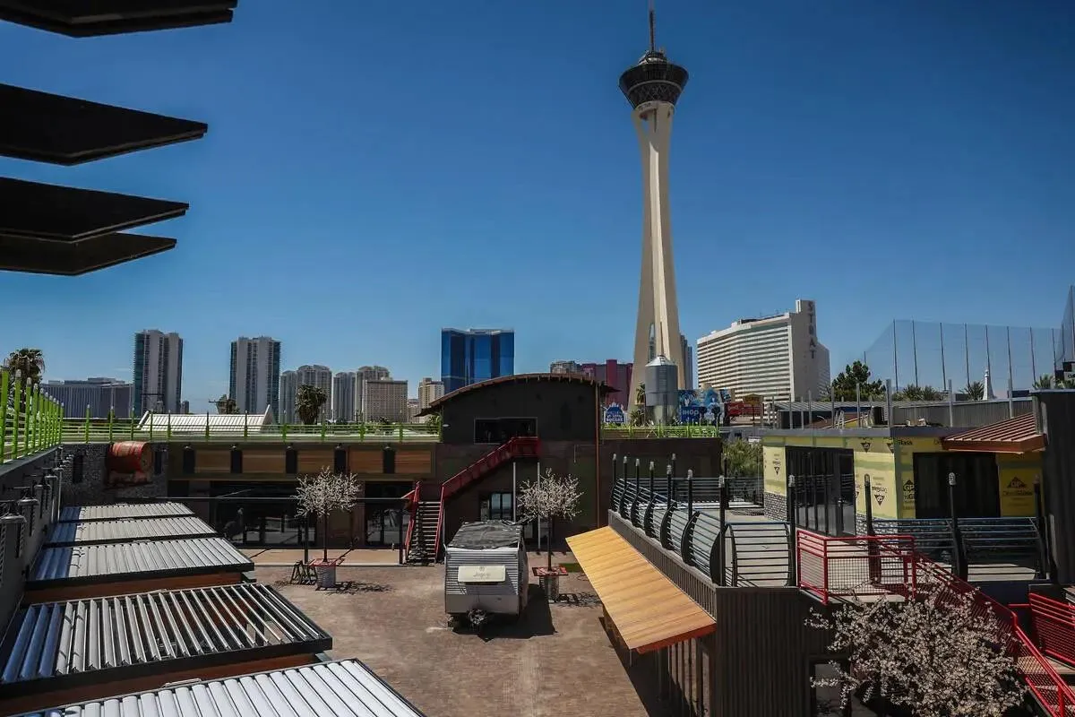 Campus Las Vegas redevelopment near Las Vegas Boulevard and Oakey Boulevard, with the Las Vegas skyline and Strat Tower visible in the background.