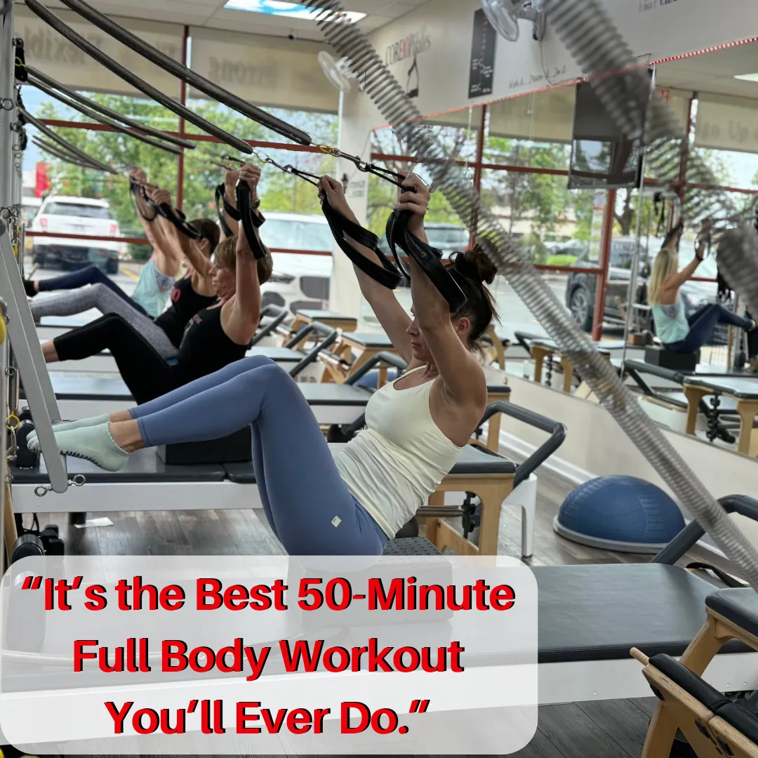 Core10 Pilates members doing a full-body reformer workout using dumbbells in a high-energy group class in West Omaha.