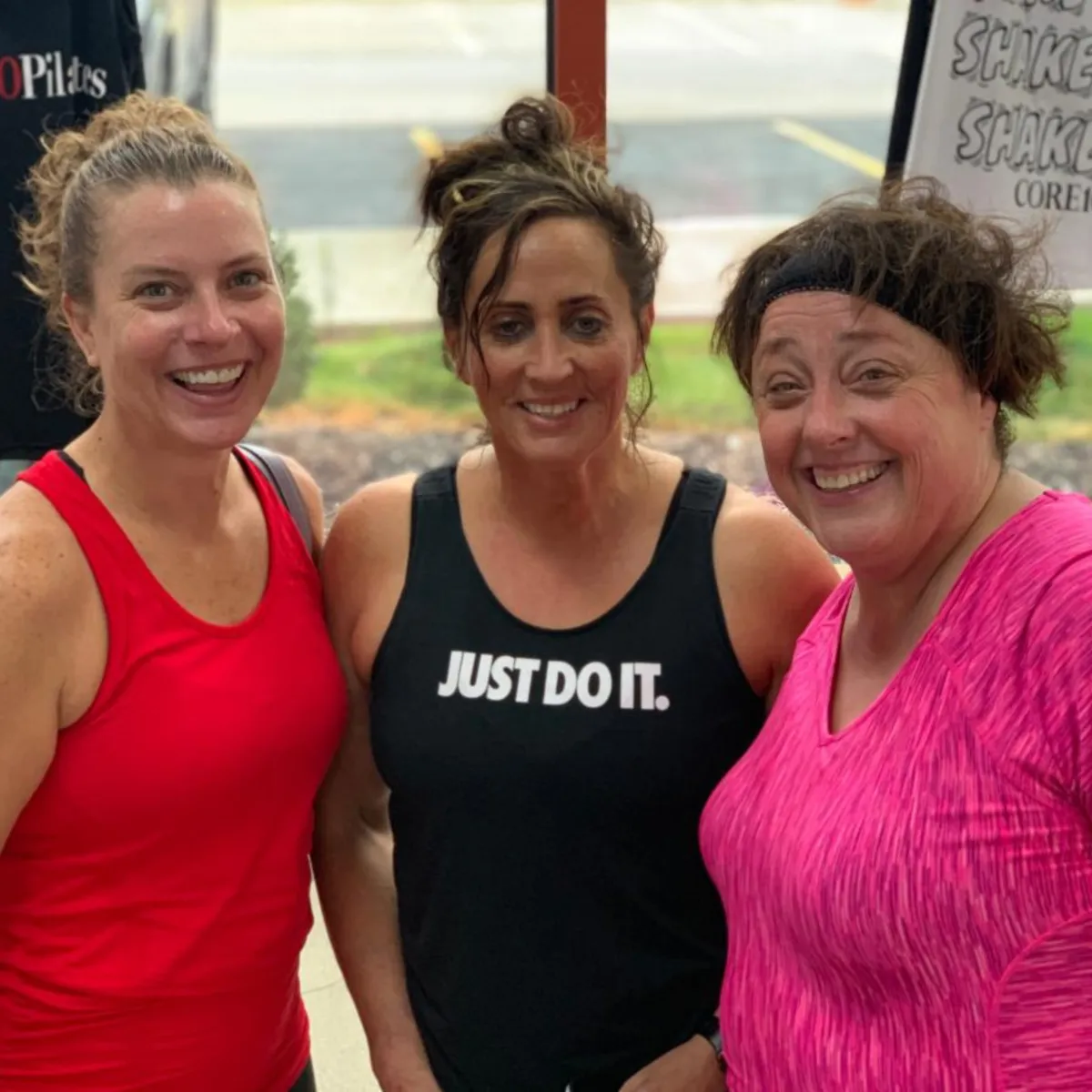 Three Core10 Pilates members smiling after class, showing strength, confidence, and community connection at Omaha’s best Pilates studio