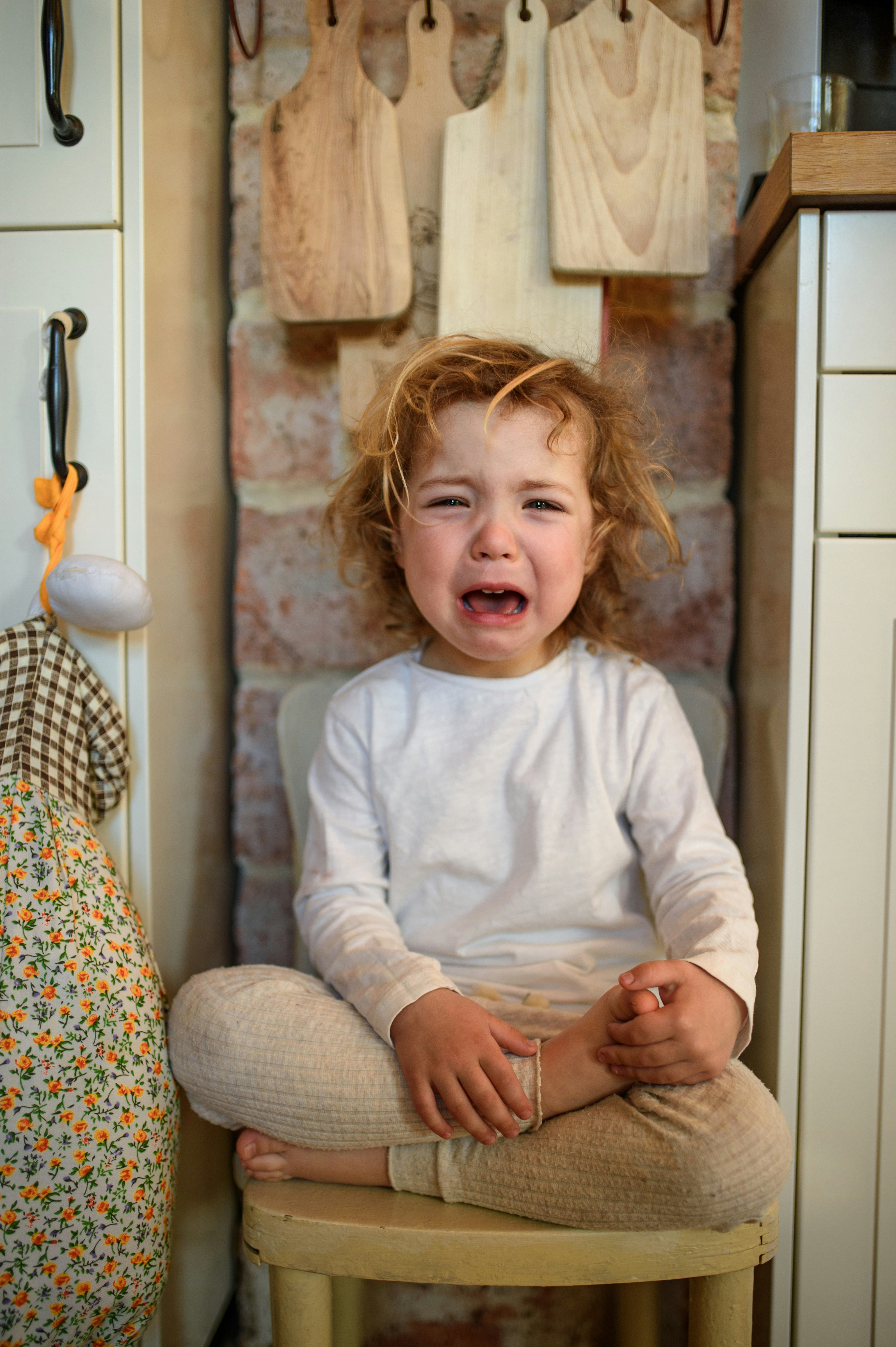 Toddler on a chair crying 