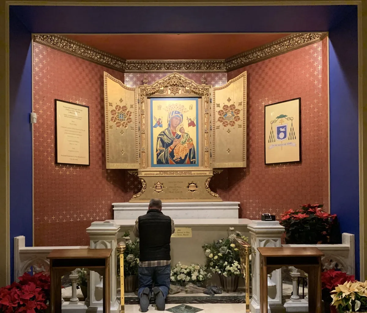Dr. Howard praying in front of the tomb of Fulton Sheen