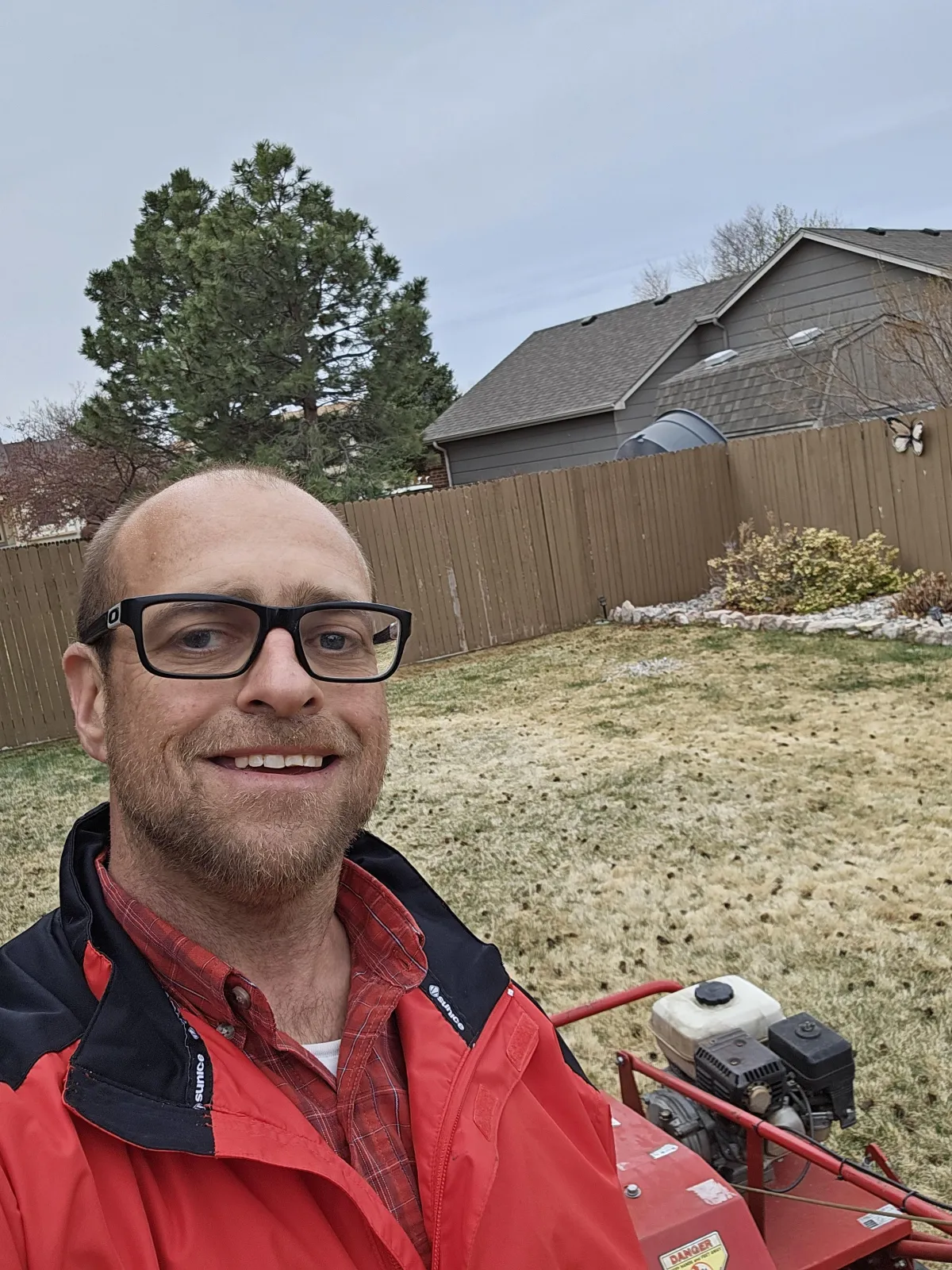 “Team member from Plant Management Landscape Solutions LLC in Colorado Springs preparing lawn care equipment for residential yard maintenance and landscaping services.”