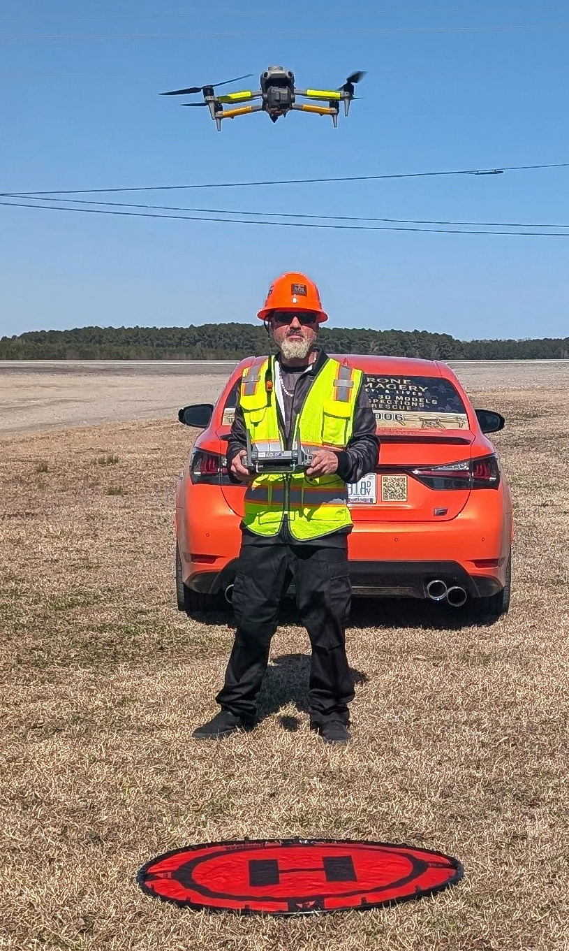 AGL drone pilot with drone and car