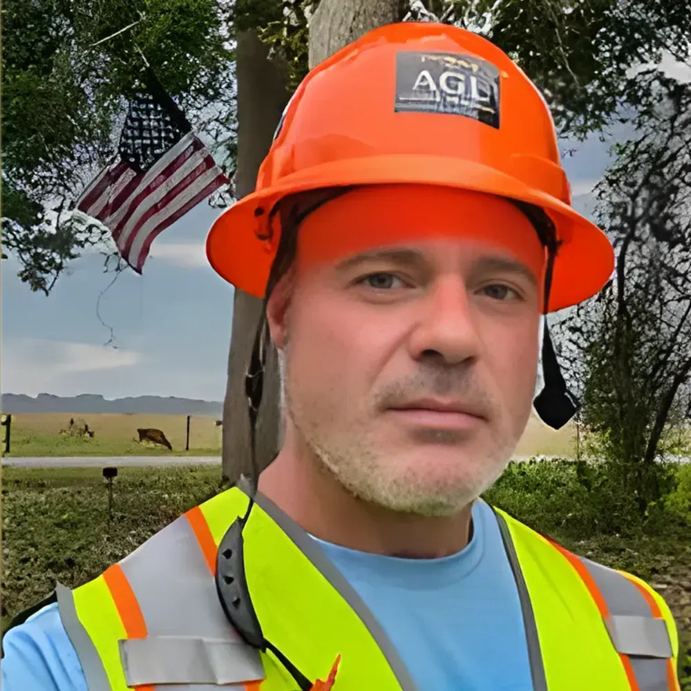 AGL drone pilot in front of trees