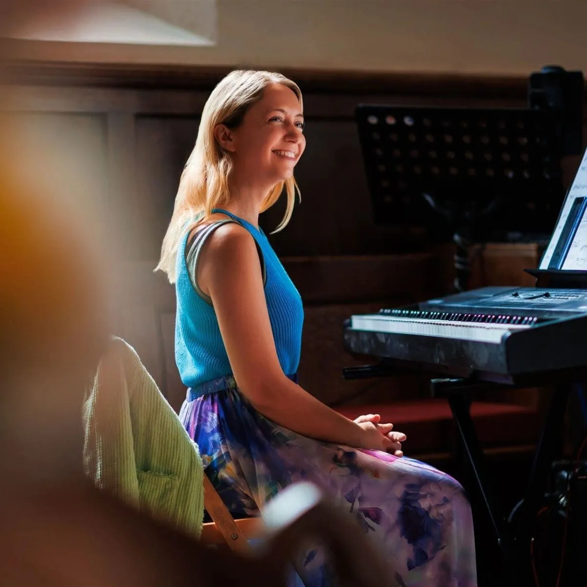 Elegantly dressed wedding guests dining in a banquet hall with live grand piano performance in the background
