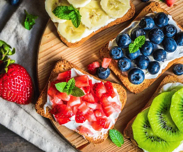 3 slices of toast each topped with a different fruit