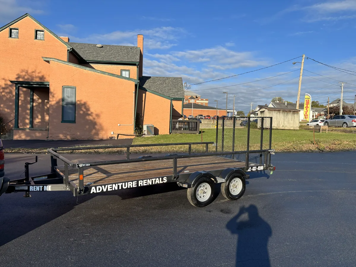 Adventure Rentals utility trailer with a wood deck, welded frame and rear gate