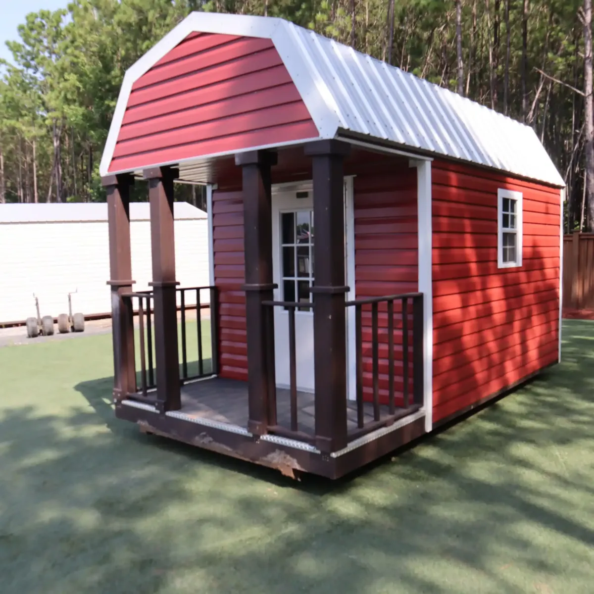 A shed in a field with a fence around it