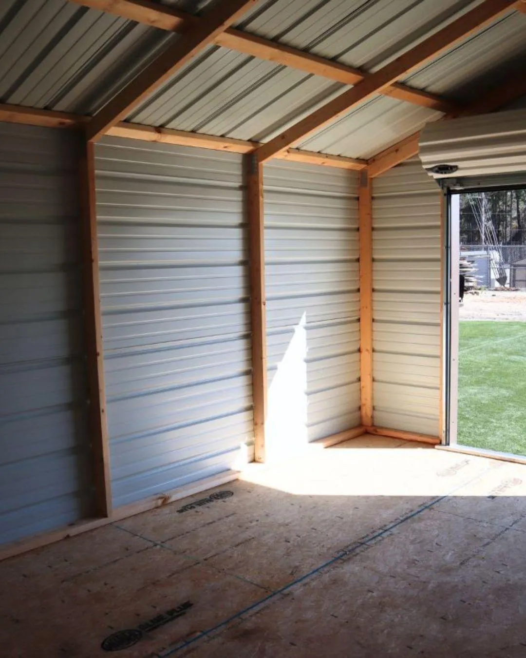 a storage shed with a shed door open